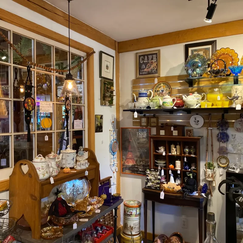 Vintage collectibles and colorful glassware inside Starshine Designs and Eclectic Finds at The Shoppes at Green Wolf’s Village Barn.